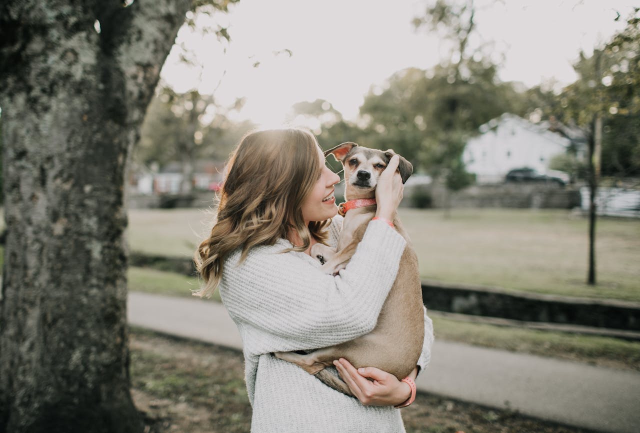 A woman holder her dog